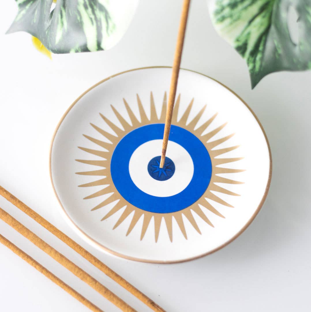 Hand made ceramic round incense holder painted in the design of an evil eye with gold highlights 