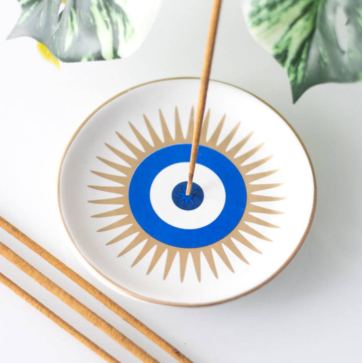 Hand made ceramic round incense holder painted in the design of an evil eye with gold highlights 